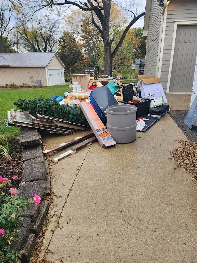 Dumpster being loaded with debris for Commercial Dumpster Rental in Ellisville